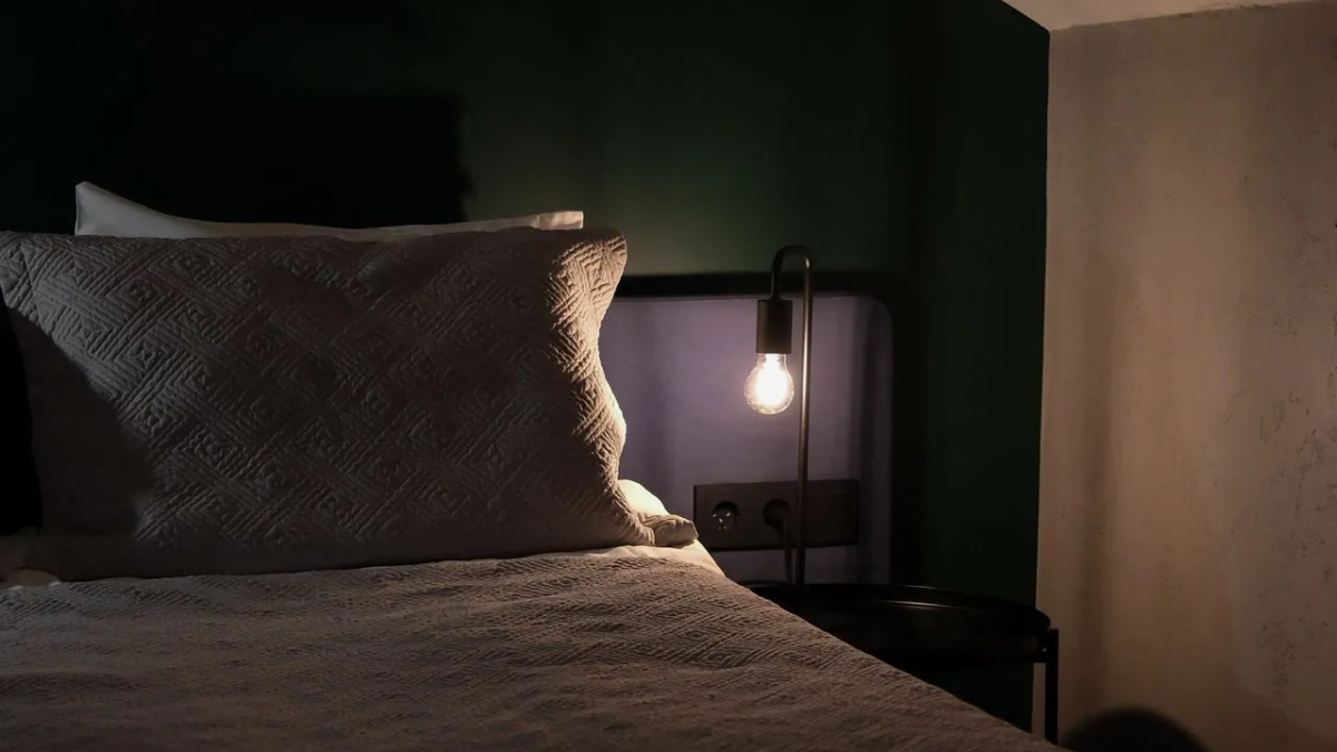 A simple, calm bedroom scene suggesting ease and rest without pressure.