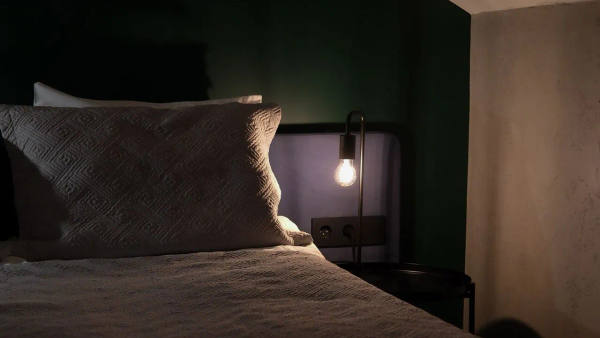 A simple, calm bedroom scene suggesting ease and rest without pressure.