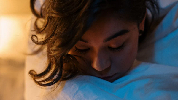 A person awake at night, suggesting difficulty falling asleep.